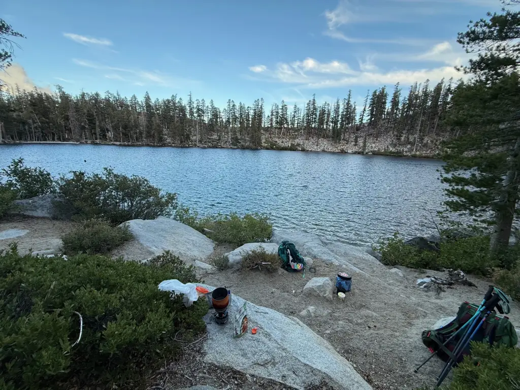 Our first campsite beside Granite Lake, with backpacks and cooking gear on the granite